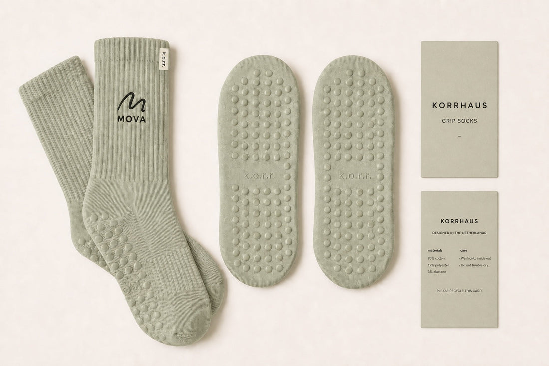 Small-batch custom grip socks for a Pilates studio with embroidered logo, branded soles and care wraps