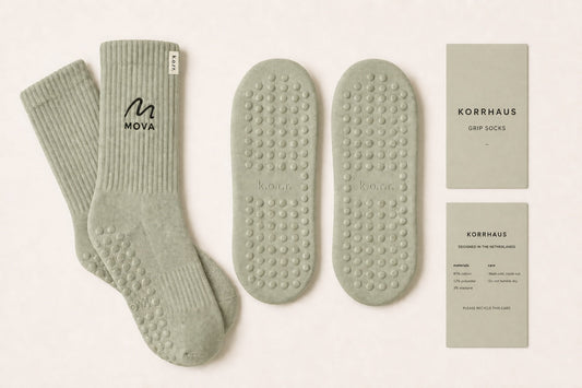 Small-batch custom grip socks for a Pilates studio with embroidered logo, branded soles and care wraps