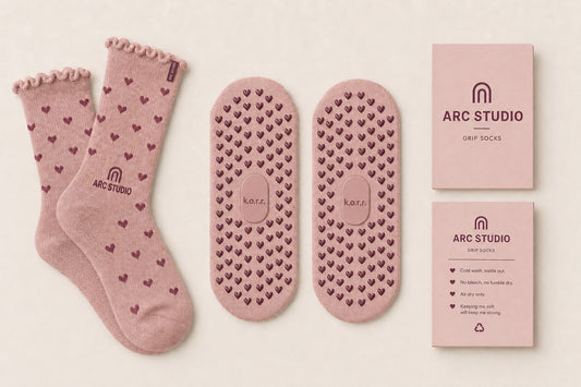 Custom ARC STUDIO grip socks with branded sole, cuff label and care wrap