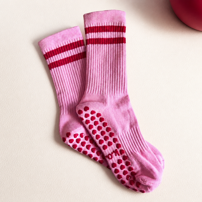 Rose Rouge pink Pilates grip socks with red stripes styled on a mat – KORRHAUS